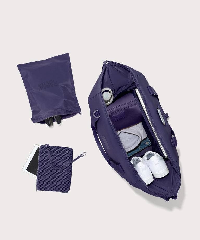  Extra Large Landon Carryall in a jewel-toned, deep blue with strong purple undertones unzipped, top down view. 

