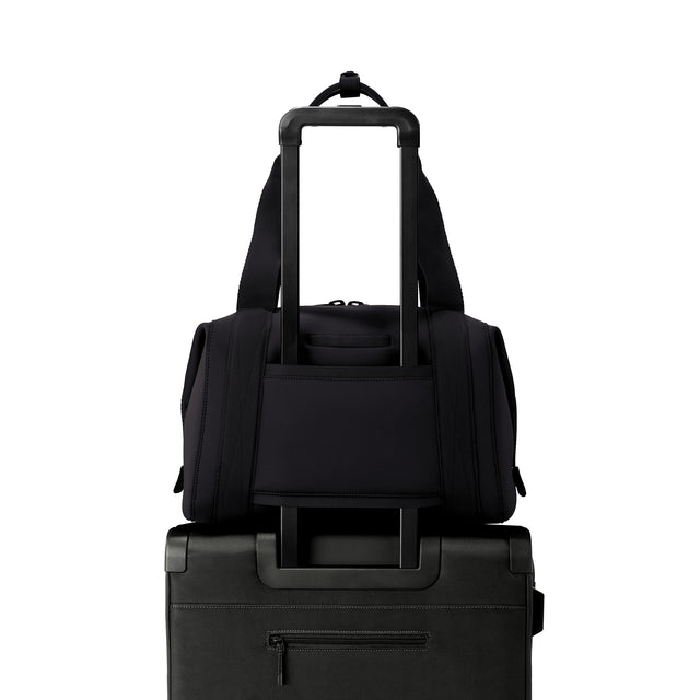 Medium Landon Carryall in black displaying luggage sleeve