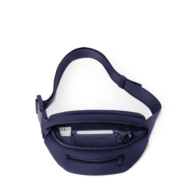 Dagne Dover Ace Fanny Pack in dark blue  unzipped, exposing the interior pockets