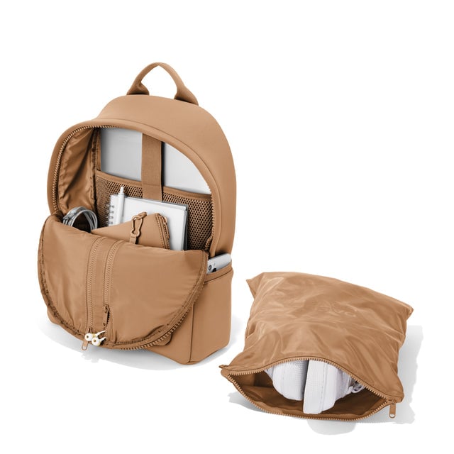Dagne Dover medium Dakota Neoprene Backpack in camel brown unzipped, showing the interior pockets and shoe bag.