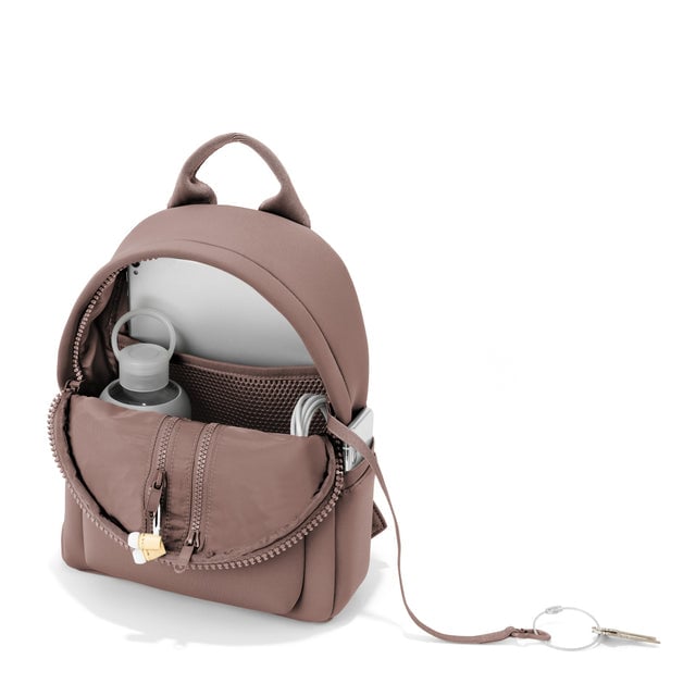Dagne Dover small Dakota Neoprene Backpack in pink unzipped, showing the interior pockets and key leash.