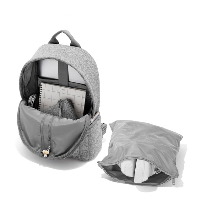 Dagne Dover medium Dakota Neoprene Backpack in grey unzipped, showing the interior pockets and shoe bag.