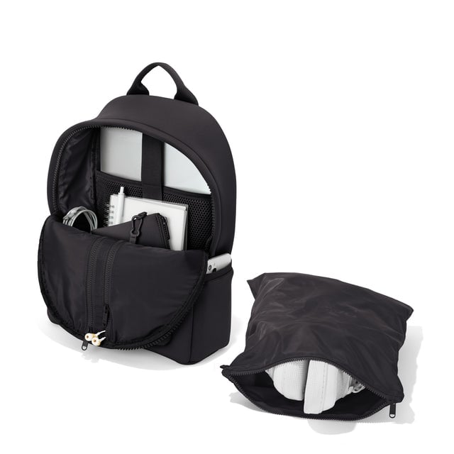 Dagne Dover medium Dakota Neoprene Backpack in black unzipped, showing the interior pockets and shoe bag.