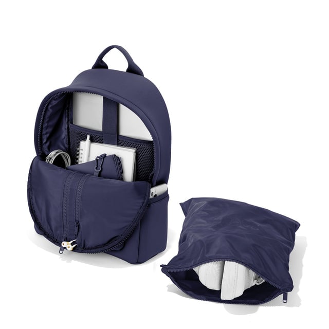 Dagne Dover medium Dakota Neoprene Backpack in dark blue unzipped, showing the interior pockets and shoe bag.