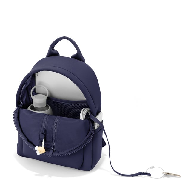 Dagne Dover small Dakota Neoprene Backpack in dark blue unzipped, showing the interior pockets and key leash.