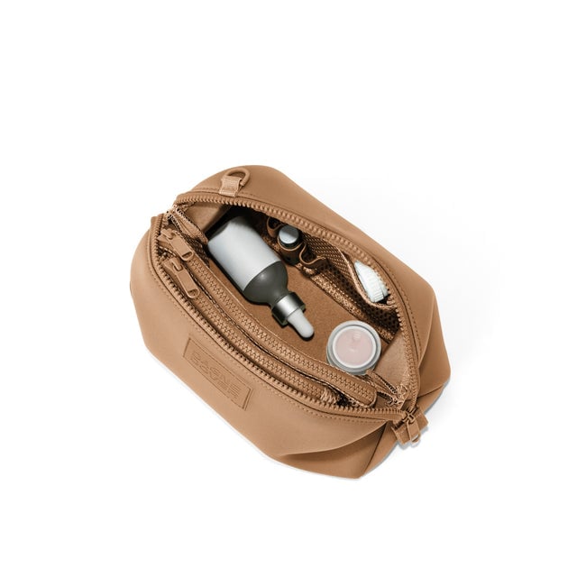 Dagne Dover Large Hunter Toiletry Bag in camel brown unzipped and seen from above.
