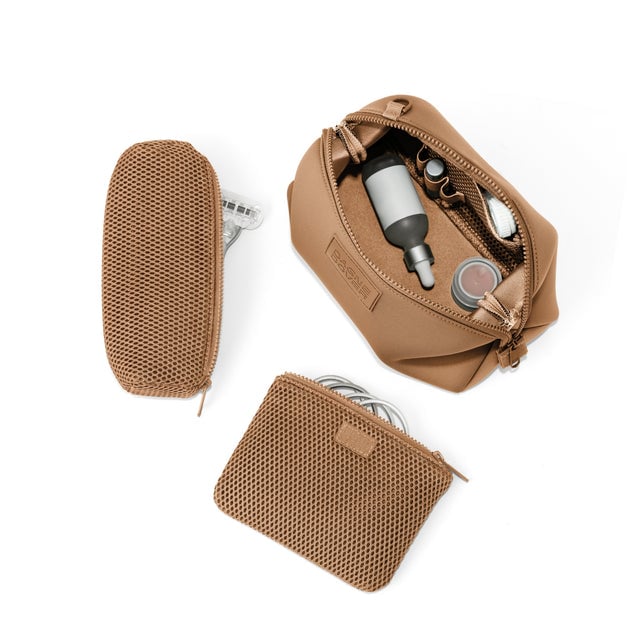 Dagne Dover Large Hunter Toiletry Bag in camel brown unzipped and seen from above with the removable air mesh pouch alongside it.