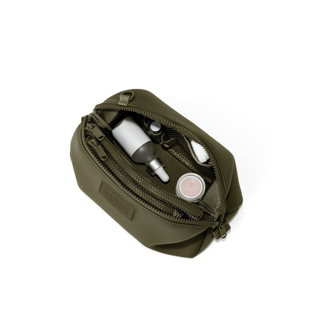 Dagne Dover Large Hunter Toiletry Bag in dark green unzipped and seen from above.