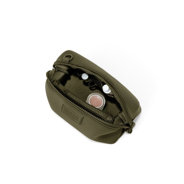 Dagne Dover Small Hunter Toiletry Bag in dark green unzipped and seen from above.