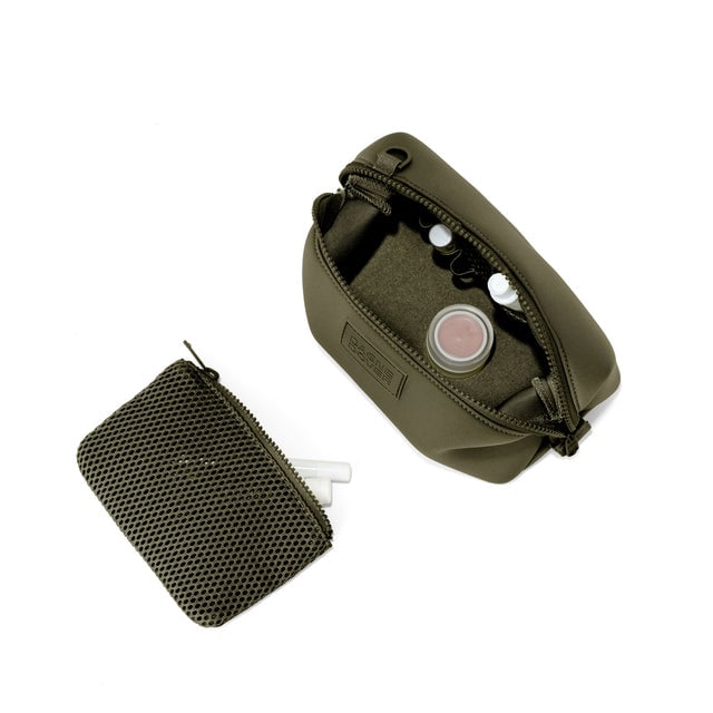 Dagne Dover Small Hunter Toiletry Bag in dark green unzipped and seen from above with the removable air mesh pouch alongside it.