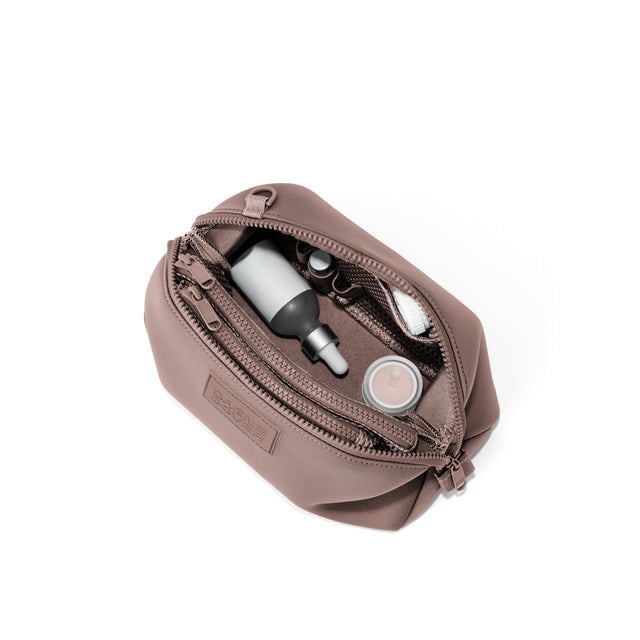 Dagne Dover Large Hunter Toiletry Bag in pink unzipped and seen from above.