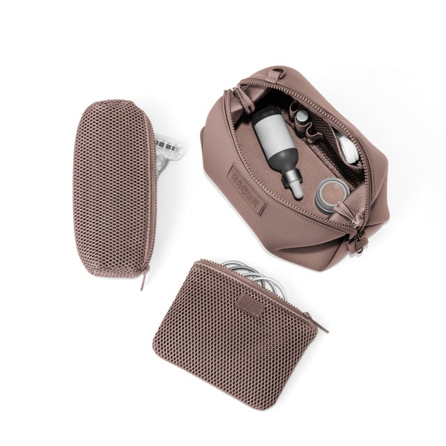 Dagne Dover Large Hunter Toiletry Bag in pink unzipped and seen from above with the removable air mesh pouch alongside it.