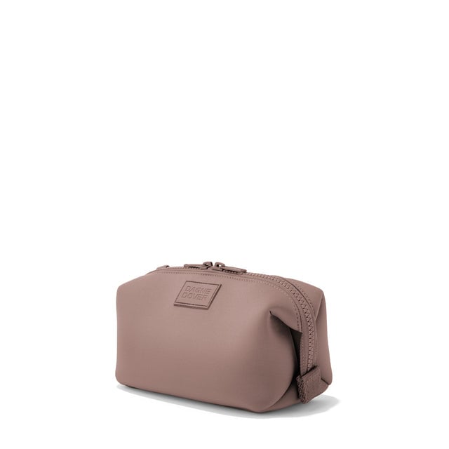 Dagne Dover Small Hunter Toiletry Bag in pink seen from an angle.