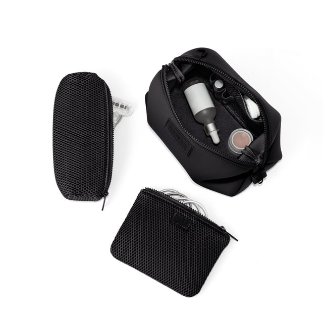 Dagne Dover Large Hunter Toiletry Bag in black unzipped and seen from above with the removable air mesh pouch alongside it.