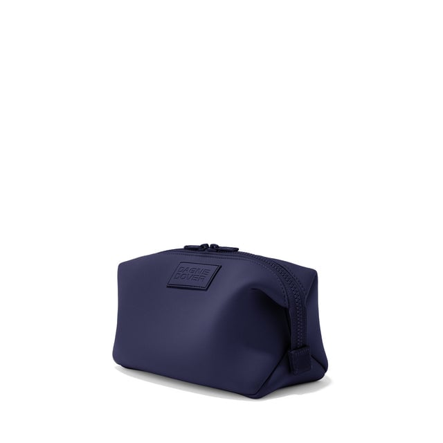 Dagne Dover Large Hunter Toiletry Bag in navy blue seen from an angle.