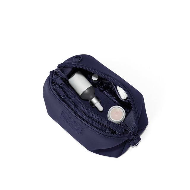 Dagne Dover Large Hunter Toiletry Bag in navy blue unzipped and seen from above.