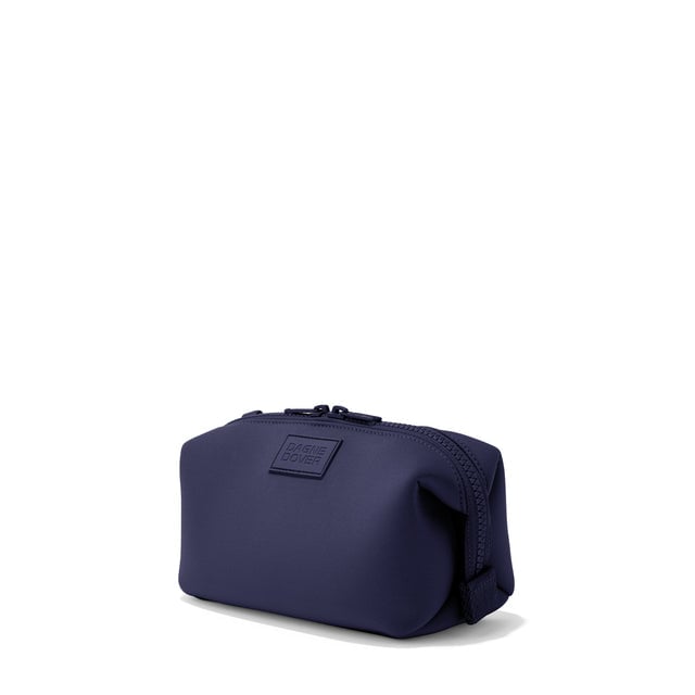 Dagne Dover Small Hunter Toiletry Bag in navy blue seen from an angle.