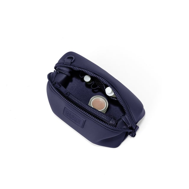 Dagne Dover Small Hunter Toiletry Bag in navy blue unzipped and seen from above.