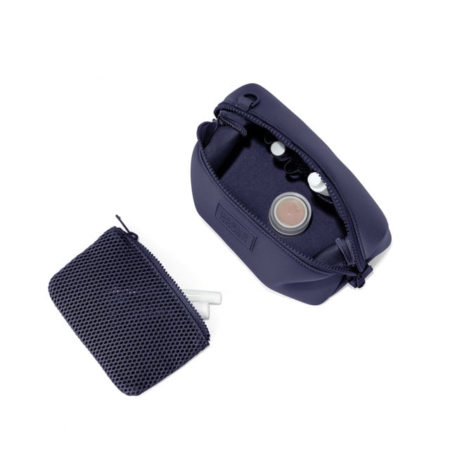 Dagne Dover Small Hunter Toiletry Bag in navy blue unzipped and seen from above with the removable air mesh pouch alongside it.