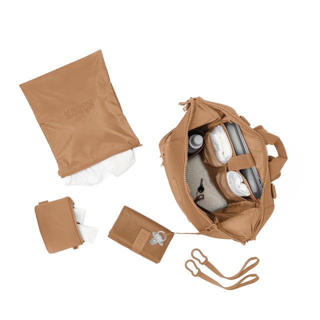 Dagne Dover Large Indi Diaper Backpack in camel brown showing it's water resistant bag, interior pockets, and changing mat.