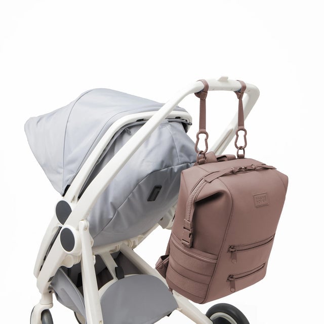 Dagne Dover Large Indi Diaper Backpack in dune pink attached to a stroller.