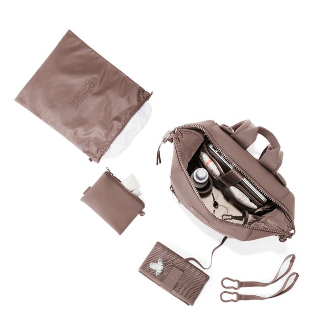 Dagne Dover Medium Indi Diaper Backpack in dune pink showing it's water resistant bag, interior pockets, and changing mat.