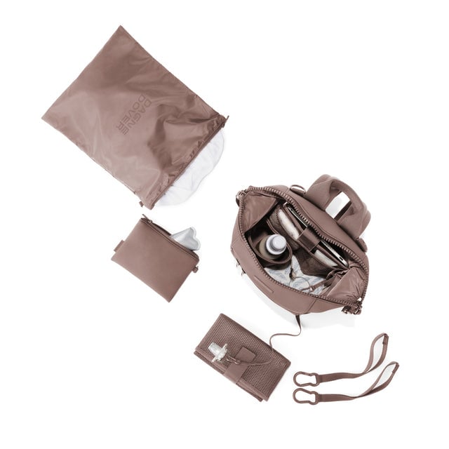 Dagne Dover Small Indi Diaper Backpack in dune pink showing it's water resistant bag, interior pockets, and changing mat.