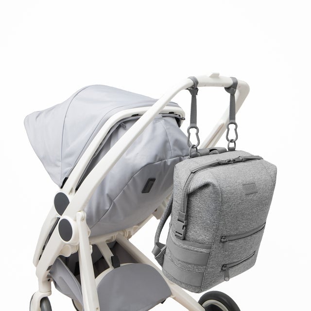 Dagne Dover Large Indi Diaper Backpack in heather grey attached to a stroller.