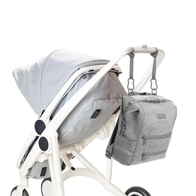 Dagne Dover Medium Indi Diaper Backpack in heather grey attached to a stroller.