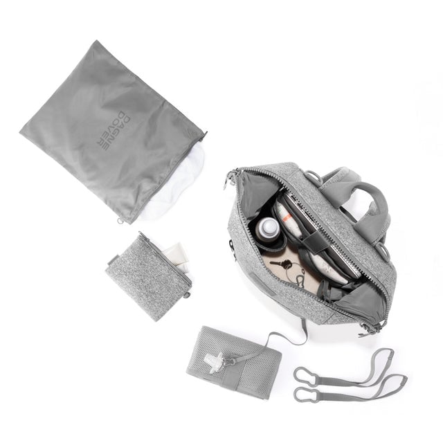 Dagne Dover Medium Indi Diaper Backpack in heather grey showing it's water resistant bag, interior pockets, and changing mat.