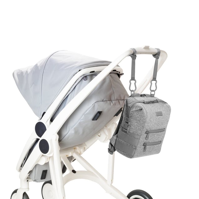Dagne Dover Small Indi Diaper Backpack in heather grey attached to a stroller.