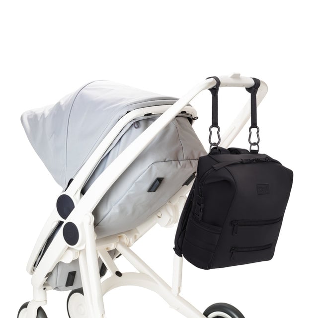 Dagne Dover Medium Indi Diaper Backpack in onyx attached to a stroller.