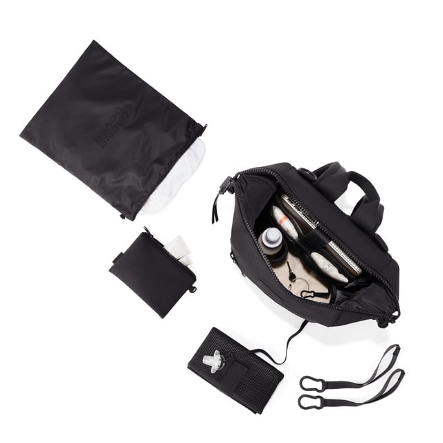 Dagne Dover Medium Indi Diaper Backpack in onyx showing it's water resistant bag, interior pockets, and changing mat.