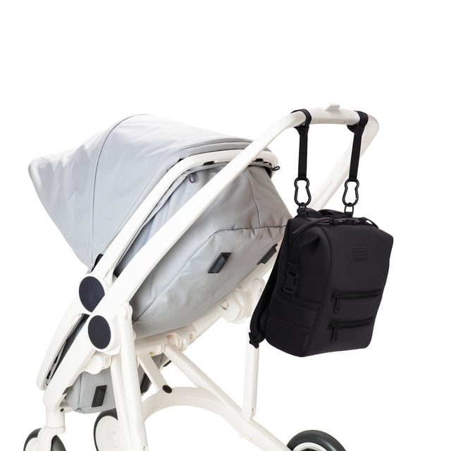 Dagne Dover Small Indi Diaper Backpack in onyx attached to a stroller.