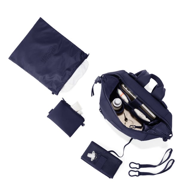 Dagne Dover Medium Indi Diaper Backpack in dark blue showing it's water resistant bag, interior pockets, and changing mat.