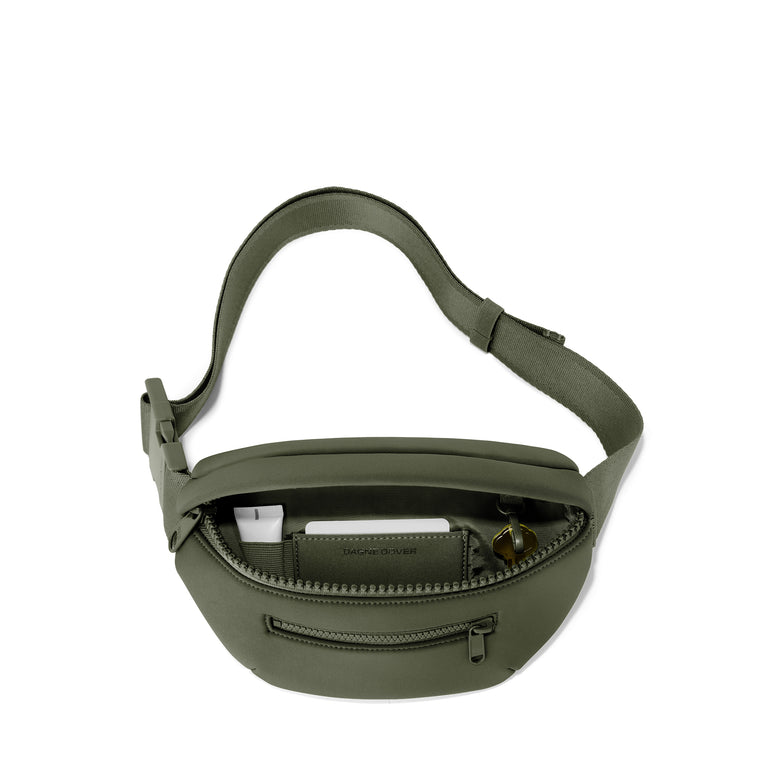 Dagne Dover Ace Fanny Pack in a cool green-grey exposing the interior pocket. 