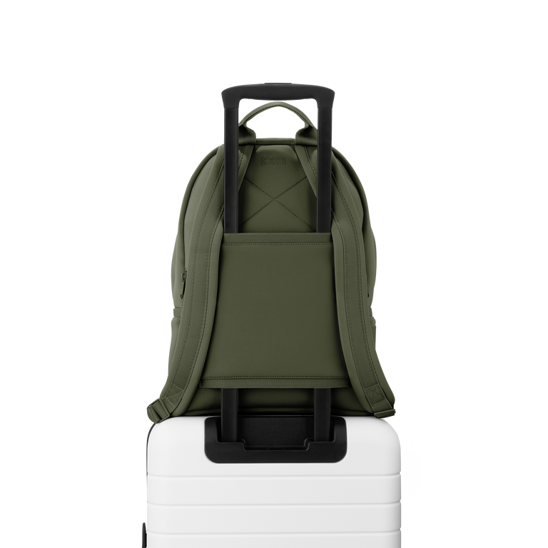 Dagne Dover medium Dakota Neoprene Backpack in a cool green-grey strapped to luggage with the neoprene luggage-handle sleeve.