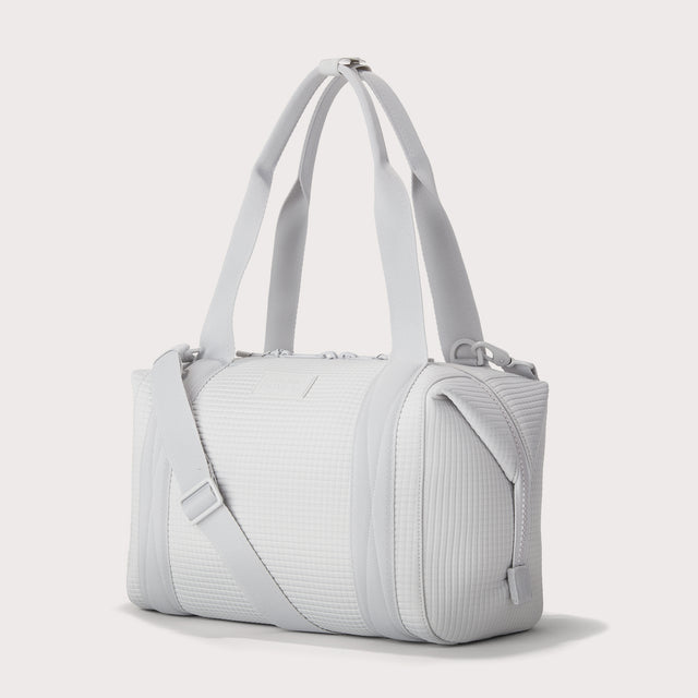 Dagne Dover Medium Landon Carryall in a muted light grey with classic waffle texture seen from the side. EDEAE8. 