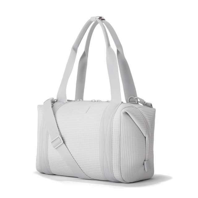 Dagne Dover Medium Landon Carryall  in a muted light grey with classic waffle texture seen from the side.