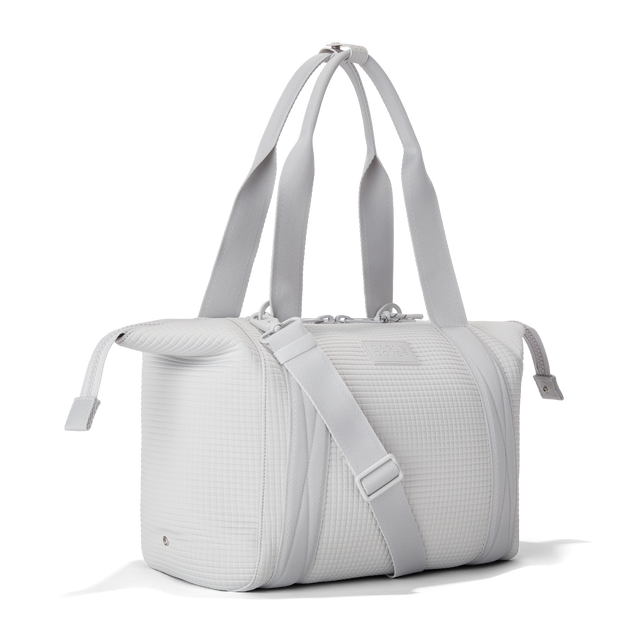 Dagne Dover Medium Landon Carryall in a muted light grey with classic waffle texture with zippers unbuckled.