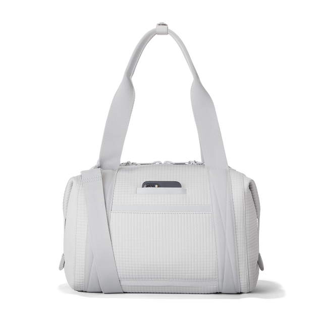 Dagne Dover Medium Landon Carryall in a muted light grey with classic waffle texture, displaying an exterior phone pocket.