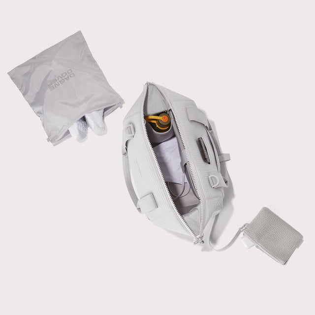 Dagne Dover Medium Landon Carryall in a muted light grey with classic waffle texture unzipped, top down view -  EDEAE8.