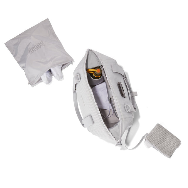 Dagne Dover Medium Landon Carryall in a muted light grey with classic waffle texture unzipped, top down view 
