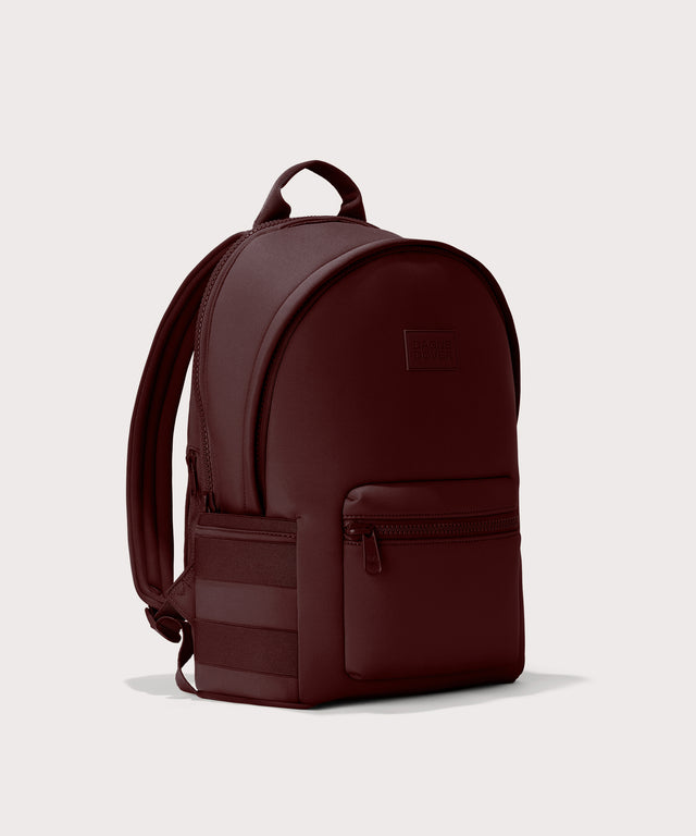 Dagne Dover Large Dakota Neoprene Backpack in a deep brown with purple undertones seen from an angle.