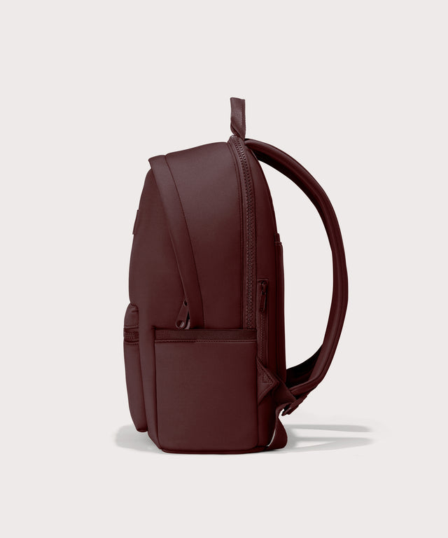 Dagne Dover Large Dakota Neoprene Backpack in a deep brown with purple undertones seen from the side.