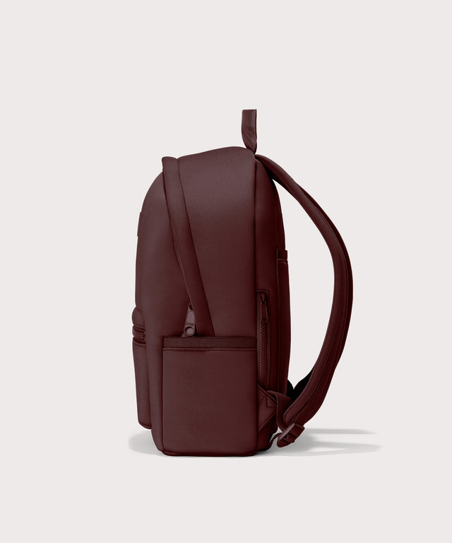 Dagne Dover Medium Dakota Neoprene Backpack in a deep brown with purple undertones seen from the side.