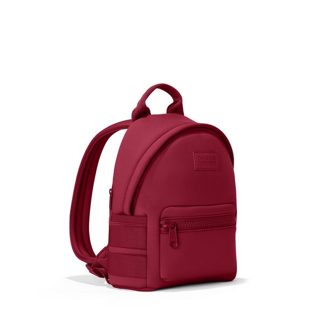 Dagne Dover small Dakota Neoprene Backpack in spice red seen from an angle.