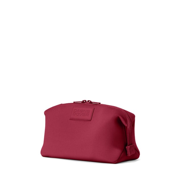 Dagne Dover Large Hunter Toiletry Bag in spice red seen from an angle.