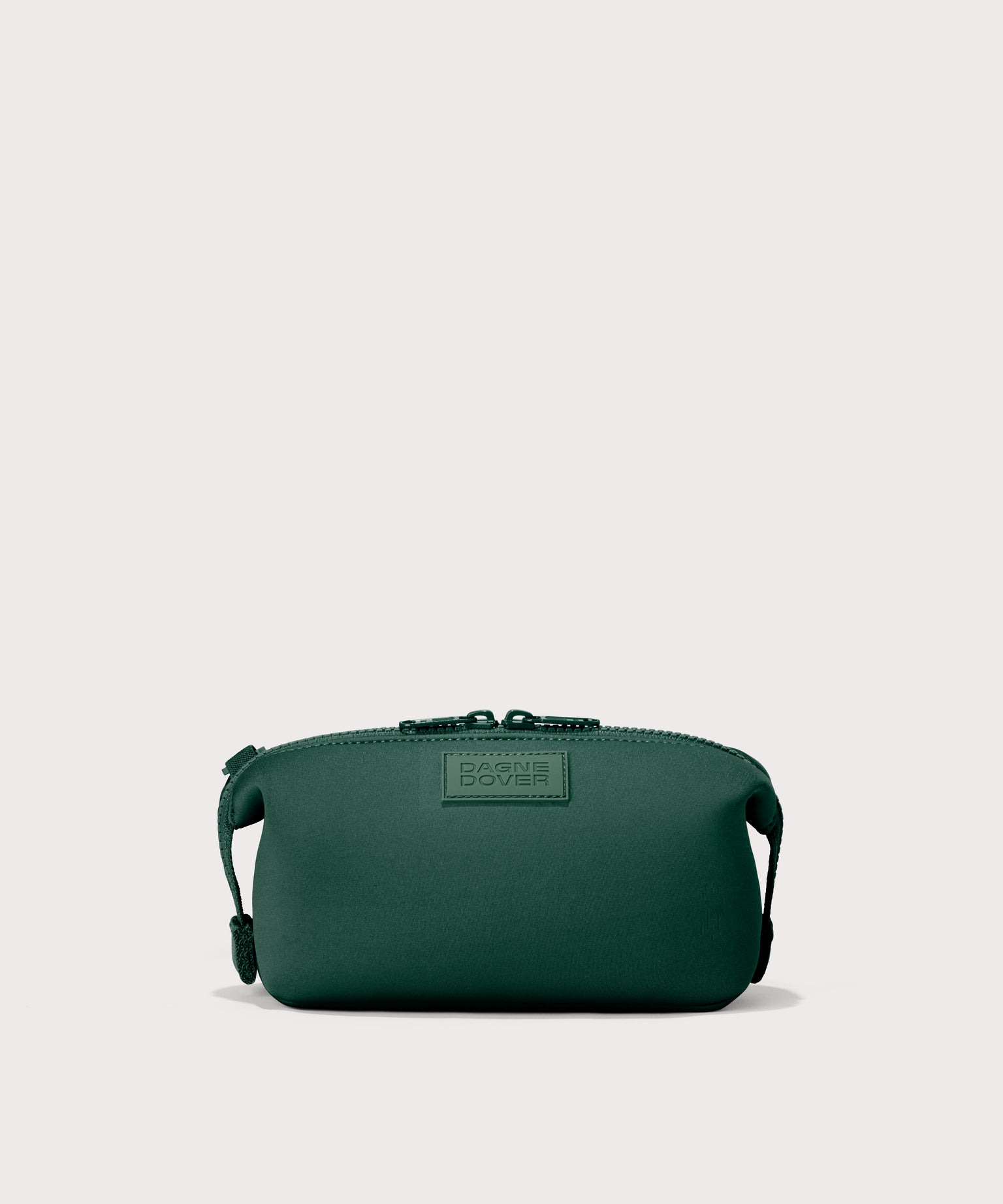 Hunter small toiletry bag in a saturated, jewel-toned deep green with bold blue undertones. Front view. 
