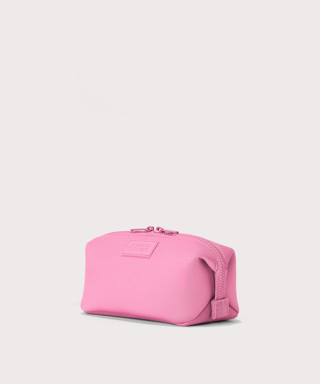 Dagne Dover Small Hunter Toiletry Bag in a true bubble gum pink seen from an angle.